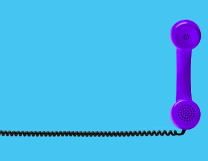 a purple telephone standing vertically on a blue background with a black telephone cord extending to the left